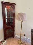 Living room. Corner curio cabinet with standing lamp. Curio is 78 inches tall by approximately 27 inches wide.