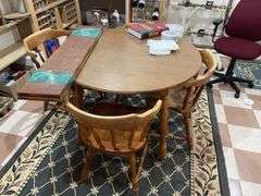 Basement. Round table with leaf and four matching chairs. Table is 42 inches across. Includes rug underneath.