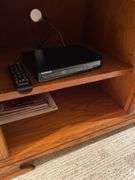 Basement. Samsung 60 inch flatscreen smart TV with Blu-ray player VHS player Maple entertainment stand, and Samsung subwoofer.