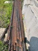 Lengths of heavy gauge pipe and approximately 30 foot long light pole/mast