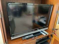 Living room. 40 inch Sony Bravia KDL – 40 XBR6 TV with remote powers on and is working includes Philips Magnavox DVD player.
