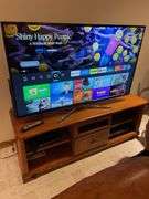 Basement. Samsung 60 inch flatscreen smart TV with Blu-ray player VHS player Maple entertainment stand, and Samsung subwoofer.