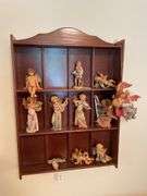 Den. Hanging curio shelf with collection of Daniella Angels.
