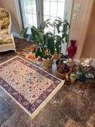 Sunroom. Two floral rugs. With decor and faux plant. Vases basket and faux plants.