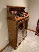 Basement. Cabinet with glass front shelves, approximately 58 inches tall and 37 inches wide.