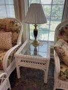 Sunroom. Lot of quality wicker furniture. Including loveseat. Two side chairs with Ottomans. Glass top wicker side tables. Includes floral cushions in good shape. With two matching lamps.