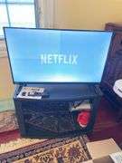 Den. 32 inch Toshiba fire TV with remote. And glass fronted entertainment stand. Powers on.