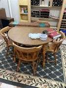 Basement. Round table with leaf and four matching chairs. Table is 42 inches across. Includes rug underneath.