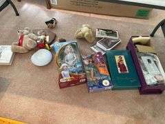 Living room. Lot of dolls and miscellaneous collectibles under table.