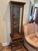 Entryway. Curio cabinet with light. 69 inches tall 19 inches wide.