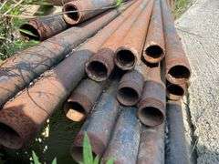 Lengths of heavy gauge pipe and approximately 30 foot long light pole/mast