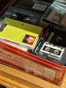 Basement. Contents of cabinet, which include VHS tapes with some well-known movies. Cassettes and CDs. Large assortment.