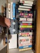 Basement. Contents of cabinet, which include VHS tapes with some well-known movies. Cassettes and CDs. Large assortment.