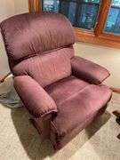 Basement. Recliner with round side table and ornate lamp.