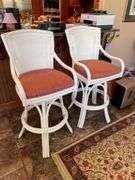 Sunroom. Two rattan cushioned rotating stools. Bar height.