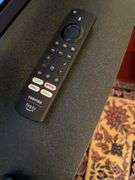 Den. 32 inch Toshiba fire TV with remote. And glass fronted entertainment stand. Powers on.