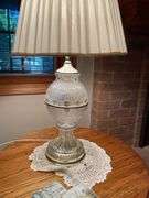 Basement. Recliner with round side table and ornate lamp.