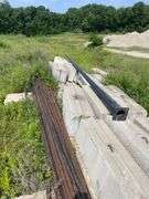 Lengths of heavy gauge pipe and approximately 30 foot long light pole/mast