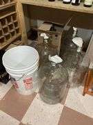 Basement. 4 each 5 gallon glass bottles, bucket