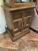 Entryway. Curio cabinet with light. 69 inches tall 19 inches wide.