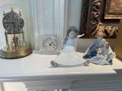 Living room. Lladro angel figurine. A mother’s touch figurine and two clocks.