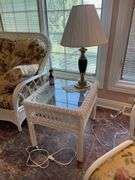 Sunroom. Lot of quality wicker furniture. Including loveseat. Two side chairs with Ottomans. Glass top wicker side tables. Includes floral cushions in good shape. With two matching lamps.