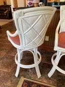 Sunroom. Two rattan cushioned rotating stools. Bar height.