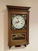 Basement. 31 day regulator clock. Approximately 24 inches tall. Includes key.