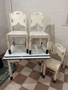 Basement. Enamel top vintage table with three matching wooden chairs. Table is 40 inches wide.