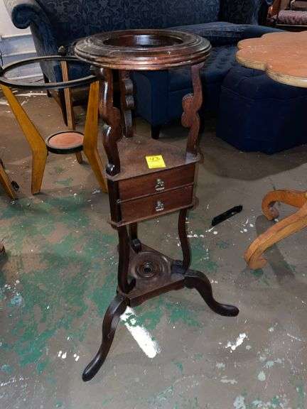 Unique depression era plant stand with two small drawers.