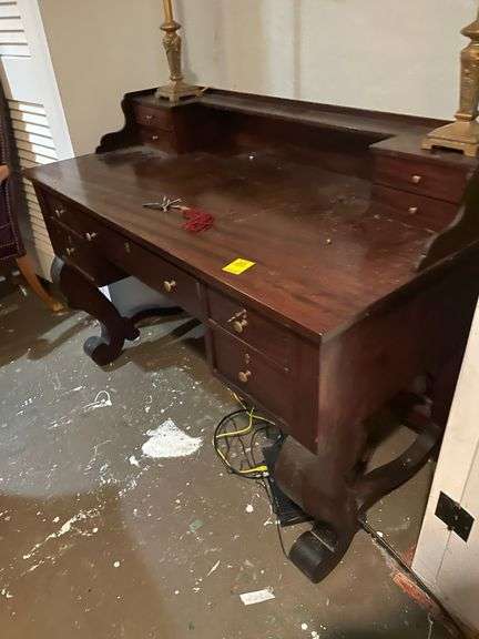 Empire style mahogany desk with stationary top and keys. 48 inches wide basement. Very nice piece includes lamps
