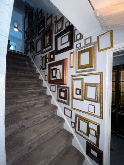 Selection of miscellaneous frames hanging in basement stairway. All for one money.