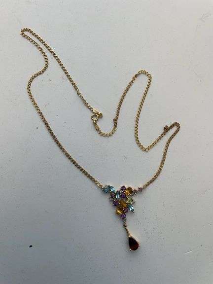 Ladies necklace engraved 10 K with charm that has semi precious stones. Total weight 5.2 g.