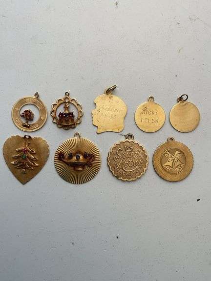 Miscellaneous charms. All engraved or acid tested 14 K. Total weight 21.7 g.