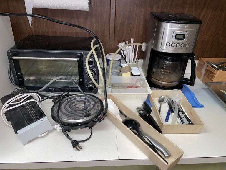 Kitchen lot include some cutlery, toaster, oven, coffee maker, and contents of upper cupboards.