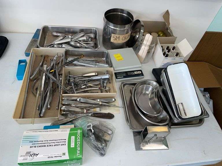 Large lot of surgical instruments includes scale, specimen, trays.