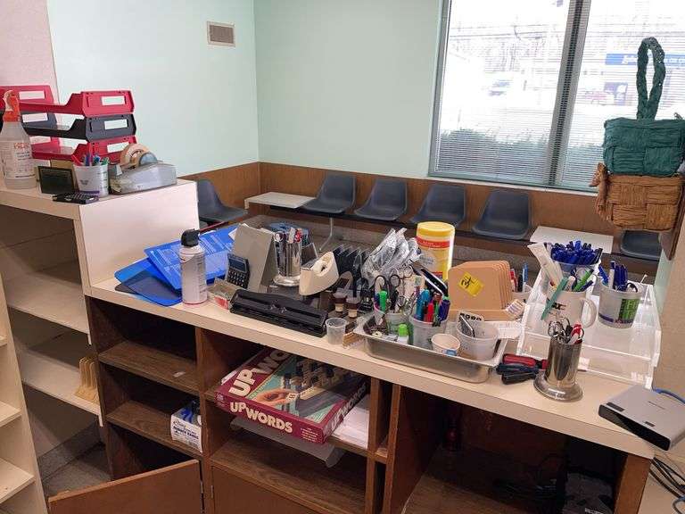 Large lot of office supplies in reception area.