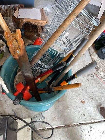 Tub of miscellaneous tools. Featuring trimmer. Pruner. Vintage snake.