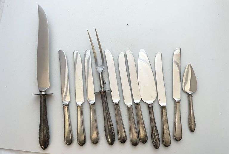 12 pieces that have sterling handles but stainless blades. total weight 929.7 g. The sterling engraving on these handles is very faint, but can be seen with a loop best to inspect at Preview. Absolutely no refunds.
