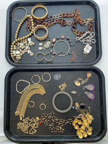 Two trays of costume jewelry. Featuring bracelets, necklaces, and more.