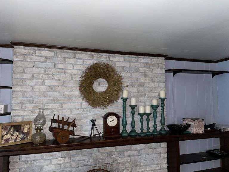 Den. Decor on top of fireplace mantle. Featuring Wellington clock. Candlesticks and more.