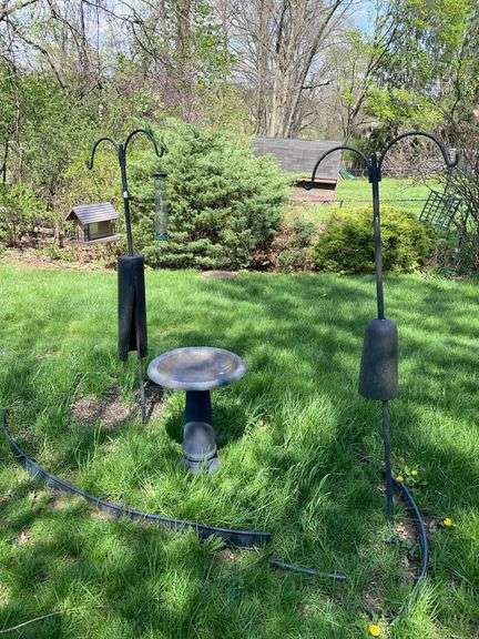 Backyard bird lot. Two double shepherd hooks with birdfeeders and birdbath.