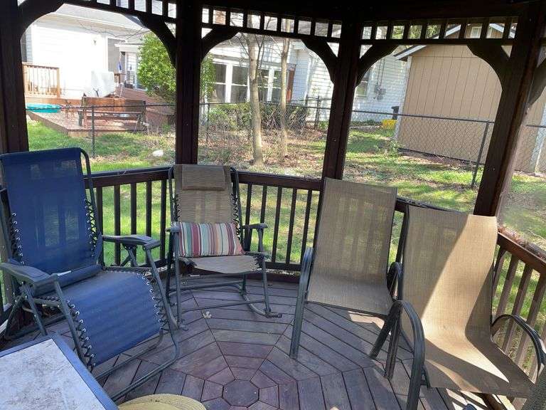 Backyard. Two outdoor rocking chair, chairs and two side chairs. These are located in the gazebo.