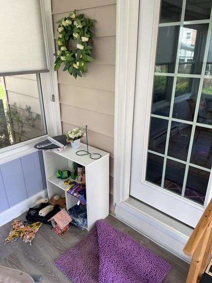 Florida room. Corner lot with shelf and decor and some miscellaneous.