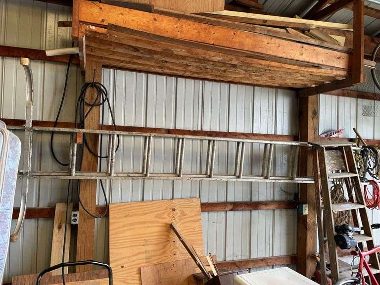 Aluminum extension ladder. Each section measures about 12 feet so we’re thinking this is an 18 foot or 20 foot ladder. Includes stability brace on top. also includes wooden A-frame ladder.
