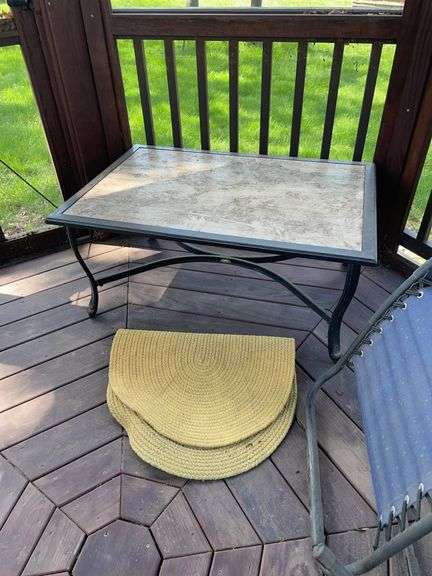 Backyard. Outdoor coffee table. 38 x 27. Outdoor mats. The large mat is 7 x 5. Locating gazebo in good condition just need cleaned