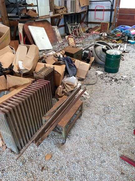 Light includes small keg, heavy metal box, miscellaneous scrap, cast radiators, and some angle and copper
