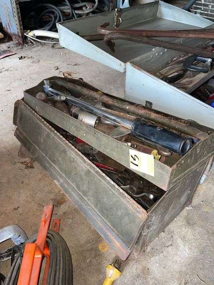 Vintage toolbox filled with miscellaneous tools. Wrenches and etc..