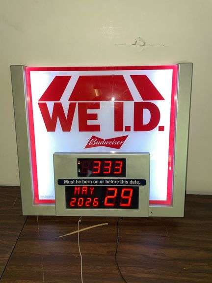 Budweiser We I. D. Light up calendar clock. Approximately 20 inches wide and 18 inches tall.