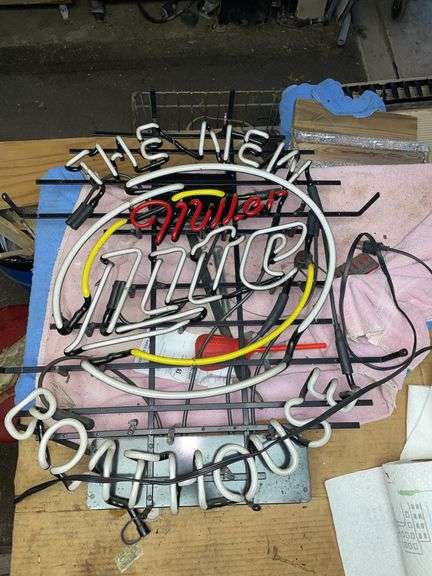 Miller light neon sign from the new boat house. When plugged in it lights for one second and then goes out. Will need some type of repair. Approximately 27 inches tall by 26 inches wide.